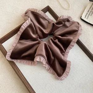 Elegant brown velvet scrunchie with lace trim edges for hair styling and wrist accessory