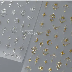 Macro shot of M-175 metallic celestial nail art stickers with gold and silver stars