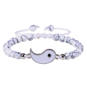 Detail of hand-woven bracelet with white turquoise beads and Tai Chi Yin Yang symbol