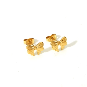 Detailed close-up of golden bow-shaped stud earrings with textured surface and pin back