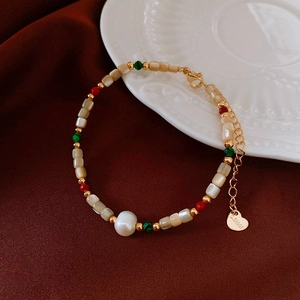Detail of 18k gold plated bracelet with freshwater pearls and colorful gemstone beads