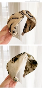 Detail of vintage floral wide headband with cross-knot design and silky chiffon texture