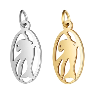 Macro detail of silver and gold stainless steel hollow dolphin pendants with connectors
