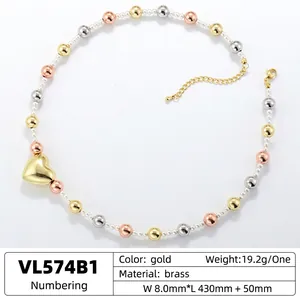 Elegant brass necklace with multi-color beads, faux pearls and a golden heart pendant