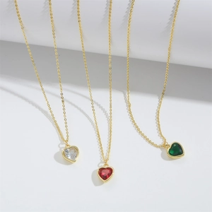 Minimalist heart pendant necklaces with red, green, and clear stones on gold chains