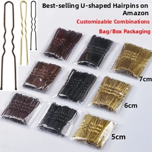 Close-up of wavy metal U-shaped hair pins in black, brown, and gold finishes