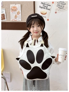 Detailed view of creative cat paw backpack with black and white 3D padded plush design