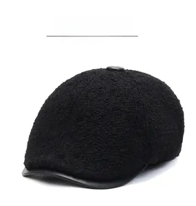 Detail of warm black beret cap featuring lamb wool texture and sleek leather brim