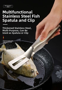 Action shot of 304 stainless steel spatula tongs flipping a whole fish in a frying pan