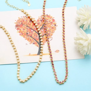 Close-up of gold plated tennis necklaces with white and ruby red zircon crystals
