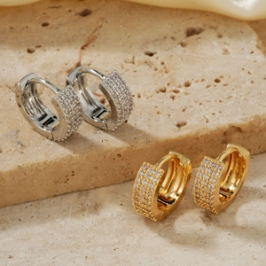 Elegant gold and silver huggie earrings with micro-paved cubic zirconia on stone base