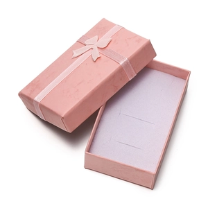 Detailed view of a pink textured jewelry gift box with ribbon bow and foam insert