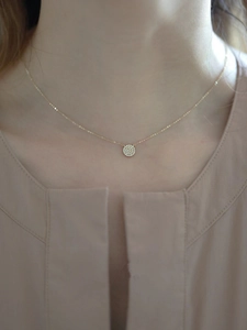 Close-up of S925 sterling silver 14k gold necklace with a round pavé diamond pendant