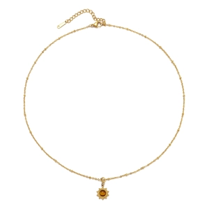 Detailed view of sun-shaped golden pendant with brown stone on a stainless steel chain