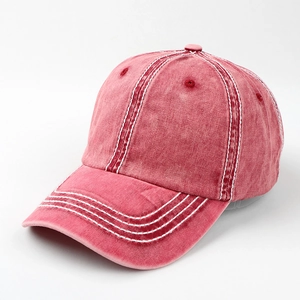 Detail of vintage washed deep red cotton baseball cap with white contrast stitching accents