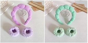 Detail of plush spa headband and wristband sets in purple and green wavy textures