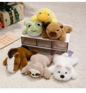 Close-up of plush capybara, horse, and sloth magnetic toys in a cozy storage box