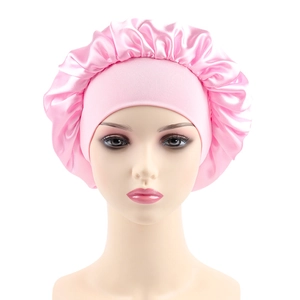 Close-up of pink satin hair bonnet featuring elastic wide band and soft pleats