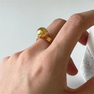 Minimalist 925 sterling silver ring with golden sphere bead worn on finger