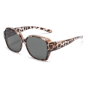 Close-up of leopard print frames and grey polarized lenses on fit-over sunglasses