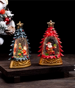 Detailed view of red and green Christmas tree crystal balls with Santa Claus on a wooden tray