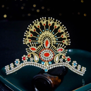 Detailed view of luxury gold crown with pearls and red and blue rhinestones
