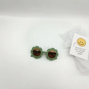 Detail of Morandi green flower shaped kids sunglasses and decorative card