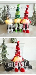 Detail of LED glowing Christmas gnomes in grey, green and red with long hanging legs