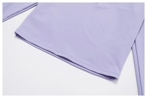 Macro detail of lavender yoga top double-needle flatlock hem and elastic performance fabric