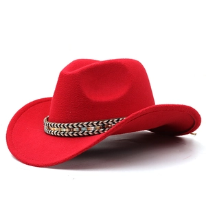 Detail of red wool felt cowboy hat featuring a colorful ethnic woven decorative band