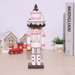 Pink nutcracker soldier doll with dessert hat on a warm Christmas themed background