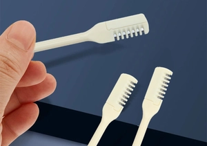 Close-up of beige dual-head manual nose hair trimmers showing precision metal blades