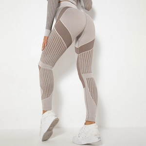 Detail of high-waisted seamless yoga leggings with light grey and brown striped texture