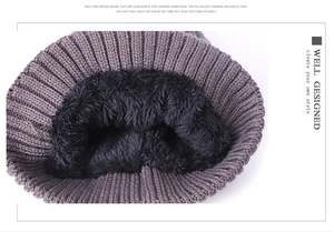 Close-up of winter knit hat with thick black faux fur lining for thermal warmth