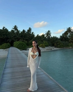 Detail of white crochet knit cover-up dress with hollow-out design for beach vacations