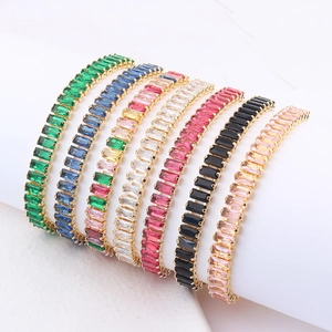 Detailed close-up of rainbow tennis bracelets with rectangular crystals in gold settings