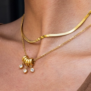 Close-up of double-layered 18K gold-plated stainless steel necklace with rhinestone pendants