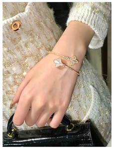 Detail of 18k gold plated iris cuff bracelet with white mother of pearl and tiny zircons