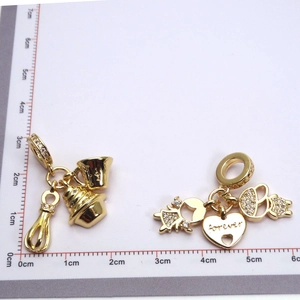 Detailed view of gold-plated culinary charms and heart pendant with Forever engraving