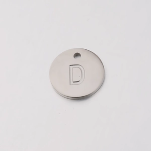 Macro view of 12mm mirror polished stainless steel charm with engraved letter D