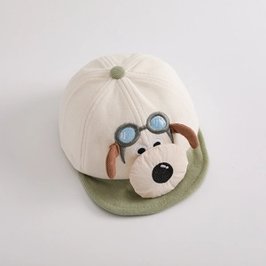 Detail of baby corduroy baseball cap with 3D cartoon dog and textured striped fabric