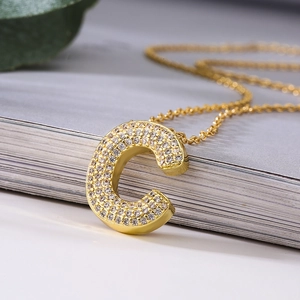 Elegant gold-tone O-chain necklace featuring a zircon pavé-set capital letter C pendant
