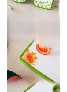 Close-up of food-grade plastic cutting board with raised edges for juice retention