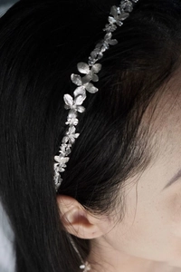 Close-up of silver floral design choker necklace worn on neck with matte metal finish