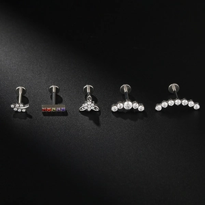 Macro shot of F136 titanium leaf-shaped labret studs with inlaid cubic zirconia crystals