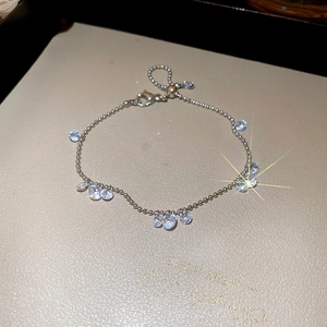 Close-up of silver bead bracelet with sparkling zircon charms and adjustable lobster clasp