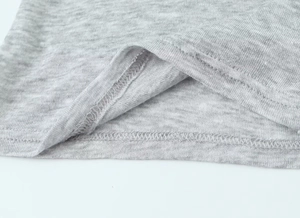 Macro shot of double-needle hem stitching on a slim-fit grey marl cotton t-shirt