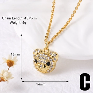 Detailed view of golden bear necklace with dimensions 13mm x 14mm on white background
