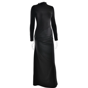 Detailed view of black long-sleeved turtleneck dress with pleated waist design