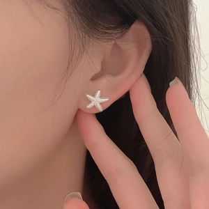 Elegant 925 sterling silver starfish stud earring with detailed beaded texture on ear